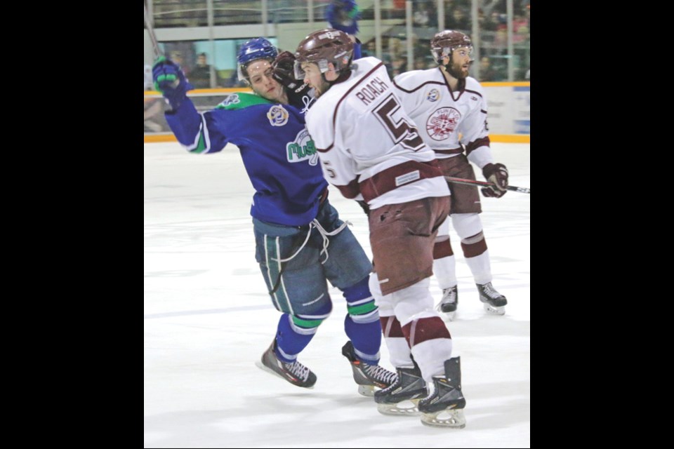 Bombers defenceman Curtis Roach collides with a Mustangs player Tuesday at the Whitney Forum.