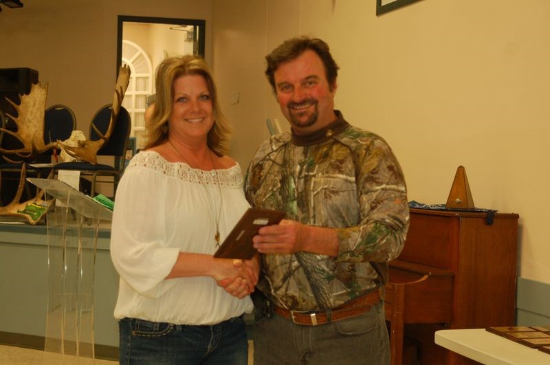 Tammy Wenc, left, was presented with the award for best women’s walleye. Rob Wilcott made the presentation.