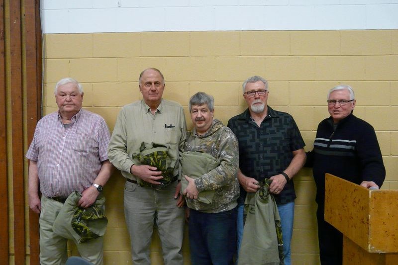 On behalf of the Norquay branch of the Saskatchewan Wildlife Federation, Bob Lumley, right, presented jackets with the name of the club and years of service on each to four long-serving members of the branch. From left, they are: George Riddell, Wilf Romanow, Jim Predinchuk and Dale Lindgren.