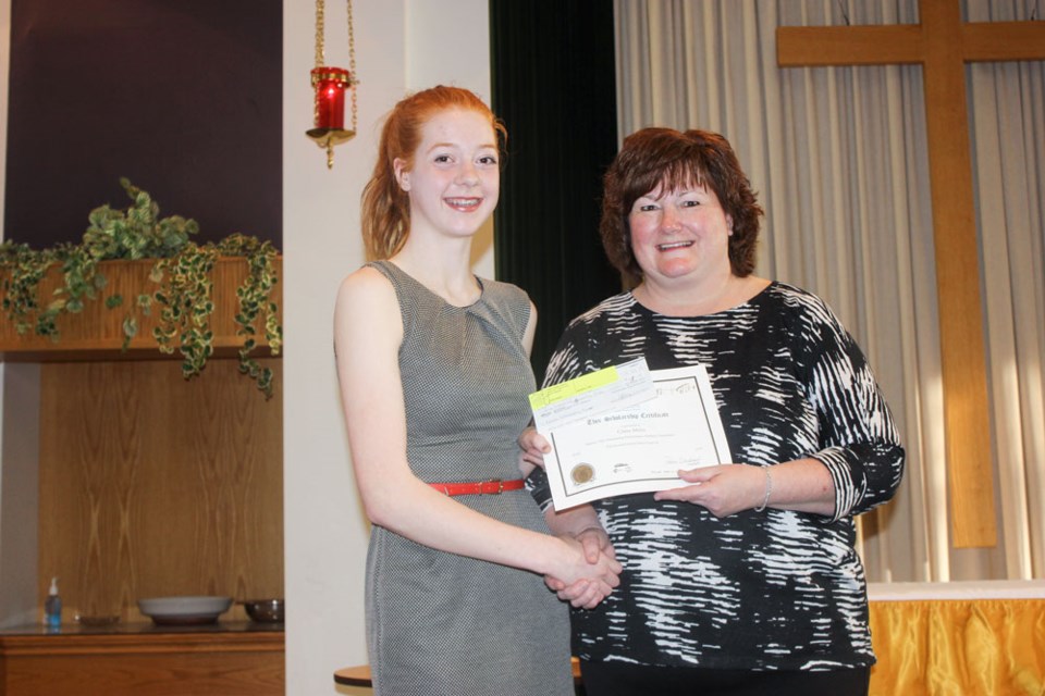 Claire Miller, left, accepted the Murray GM Award for Outstanding Performance in Multiple Disciplines from music festival president Pam Dechief.