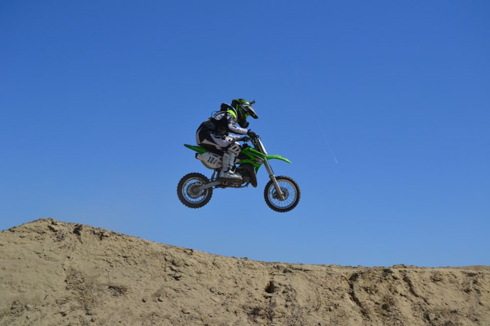 A young rider catches some air on Saturday morning, as part of the preliminary heat races, at Trackside MX Park. The motocross event saw participants of various ages speeding around Trackside’s course, around bends and over steep jumps.