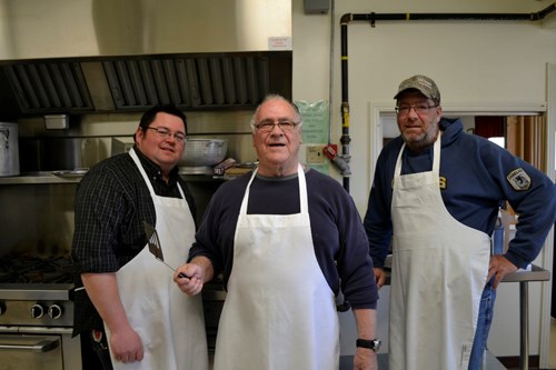 “This is a day for the community to come together,” said Shannon Houff of the Wawota Business Enhancement Group (WBEG). “We're ready to show what community is all about. We had a relatively short time to pull this day together and we've had great community support.” Pictured are three of the volunteers who made the pancake breakfast possible: (l-r) Shaun Galger, Dan Nicurity and Garry Wilson. (Staff photo by Lynne Bell)