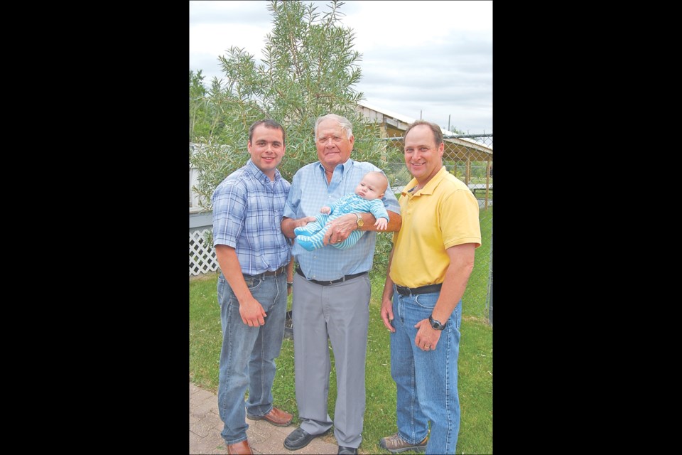 There are generations of hockey players in the Milburn family, including former Michigan Wolverine Joe Milburn (right) and former Flin Flon Bomber captain (and Joe’s son) Marc Milburn (left). In the middle, Joe’s dad Don holds his great-grandson (and Marc’s son) Shiloh, who has not made his mark in the hockey world – yet.
