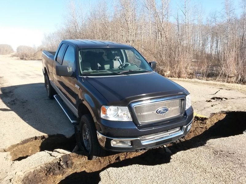This is a photograph that James Perry of Kamsack took of his pick-up truck which dropped into a crack on the Manitoba side of Highway No. 5 east of Togo on April 21.