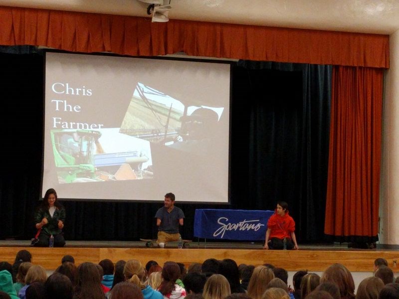 During a motivational talk delivered to students at KCI by Chris Koch, an Alberta native who had been born without legs and arms, a competition was held to see who could open a water bottle without using hands or fingers. From left, were: Curyine Stonechild, a Grade 11 student; Koch and Ethen Krawetz, a Grade 7 student. Koch had his bottle opened in seconds using what arms he does have and his teeth, while Stonechild and Krawetz took almost a full minute to accomplish the challenge.