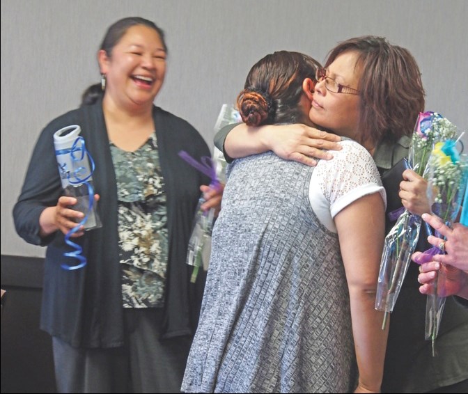 Gillian Linklater (centre, left) thanks her instructor, Roxanne Qzance, after receiving a certificate acknowledging her completion of the JobFind program, alongside Creighton Work Prep Centre job coach Theresa Wride (left).