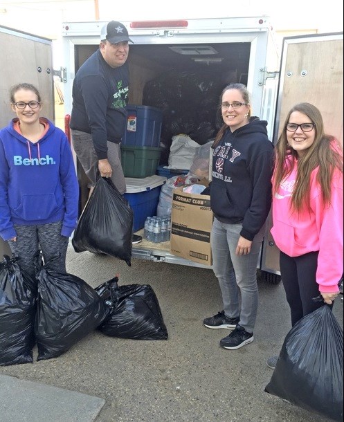 John Paul II Collegiate Mission Team recently donated items to Fort McMurray evacuees and spent a day in Edmonton sorting and boxing the items. The team has also organized food drives for the local food bank and raised funds for the Canadian Cancer Society. Photos submitted