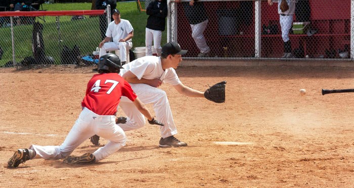 … Safe! Graeme Wilgosh of the Richardson Pioneer Bantam AA Cardinals slides into home just as the pitcher of the Regina White Sox catches the ball Monday afternoon. Cardinals defeated the White Sox in this turnaround match, 12-11, and won again during the second match, 14-6.