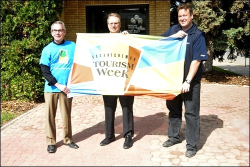 At City Hall Monday, Mayor Ian Hamilton, Owen Einsiedler (Tourism Saskatchewan) and Ryan Bater (Destination Battlefords) were on hand to raise the Tourism Awareness Week flag.