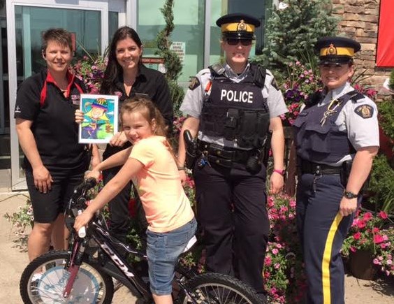 Front, Elizabeth Duff. Back row from left, Tina Lang, Sports Manager, Angie Johnson, General Manager of Canadian Tire, Cst. Kristen Guspodarchuk and Cpl. Kim Stewart.