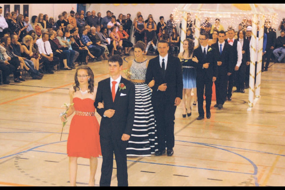 Cole Bilanchuk and his escort Corianne Metherell led the SCHS graduation class in a final grand march after the Sturgis graduation exercises.