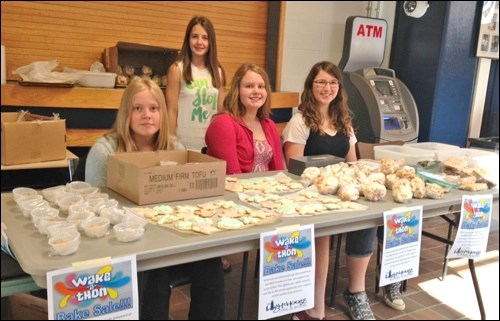 Students selling baked goods Monday after the wake-a-thon. Items were prepared during the night with proceeds supporting The Lighthouse.