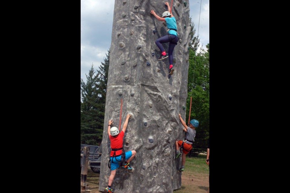 Students were up for the challenge of climbing the rock wall in Preeceville on May 24. From left, were: Zander Neitling, Jillian Newton and Brady Kashuba.