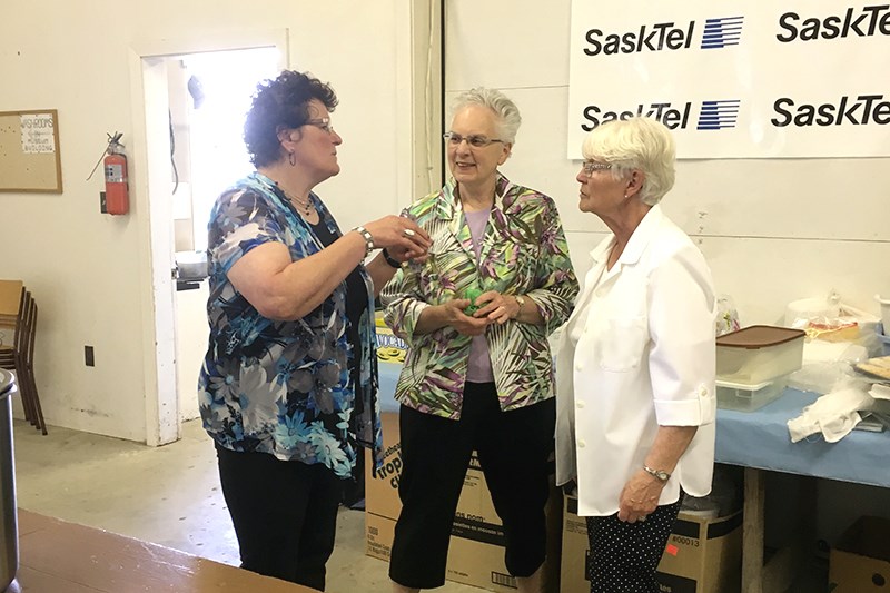 Jeannette stringer, left, of the Saskatoon Doukhobor Society, who had led the prayer service preceding the meal at Veregin on June 5, was photographed chatting with Eileen Konkin and Sonia Tarasoff, who are heritage village board members.