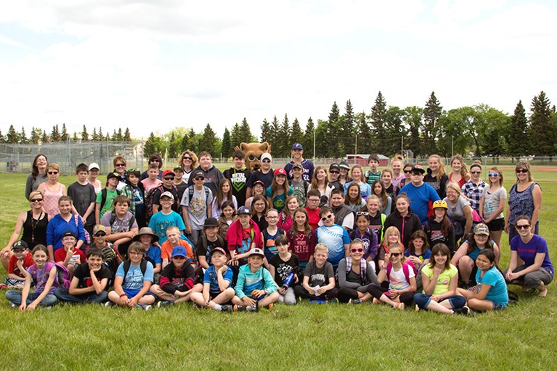 Students attending a Western Major Baseball League game between the Yorkton Cardinals and the Swift Current Indians on June 2 assembled for a group photo with the Cougars’ mascot.
