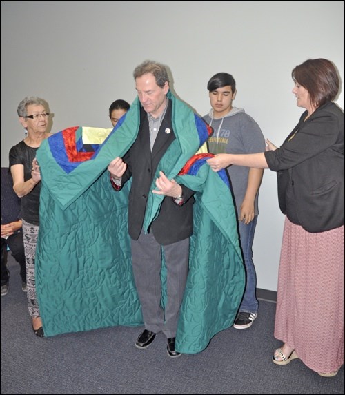 A star blanket quilt is presented to Randy Fox by two Cando Community School students on behalf of Living Sky students. Photos by John Cairns