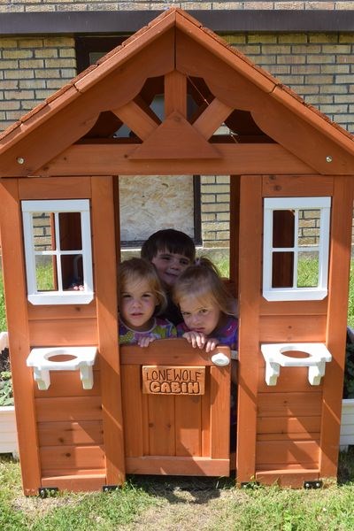 With a donation from Norm Graham and Kerry Ann Nunn of Lone Wolf Logging, KamKids Daycare purchased a playhouse, dubbed the Lone Wolf Cabin, and miniature sets of tables and benches to the KamKids Daycare in Kamsack. In the cabin last week, from left, were: Bridgette Lukey, Silas Guillet and Jordan Lukey.