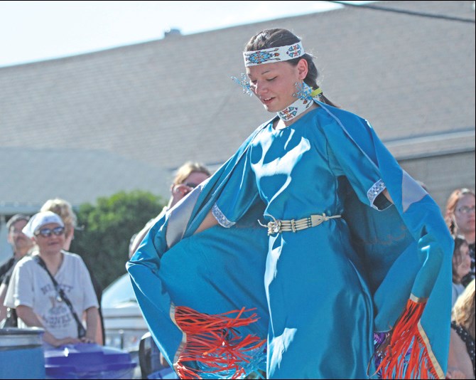 Trina Custer was one of several young women performing a pow wow dance in a fancy shawl. The fancy shawls, part of traditional regalia, were crafted by local youth with community helpers.