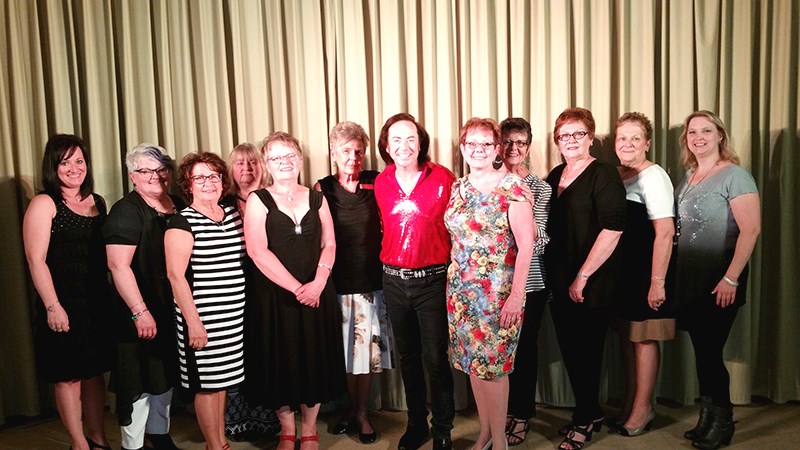 A photo was taken to commemorate the concert with, from left, Shawna Leson, Karen Wishlow, Gladys Tomski, Val Morozoff, Sharon Ciesielski, Bobby Bruce (Nearly Neil Diamond), Julia Westerman, Dodie Litowitz, Nancy Leson, Darlene Senkow, and Catherine Holt. Cynthia Gazdewich and Bev Fransishyn were not available for the photo.