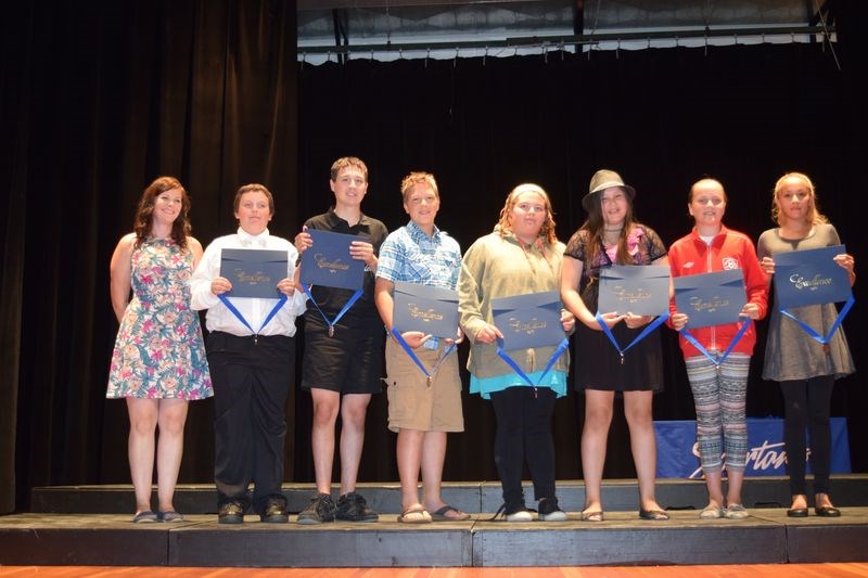 Kristen Doyle, left, presented the Arts Smarts Award, from left, to: Charles Spence-Gaines, Zachary Zbeetnoff, Nicholas Bielecki, Charlotte Henderson, Tynika StrongEagle, Jordan Thomas and Petrie Whitehawk.