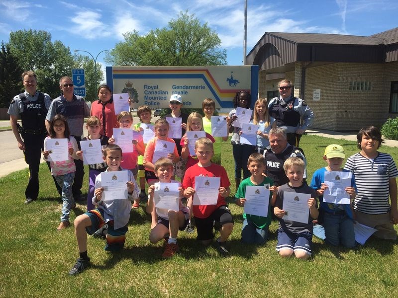 The 18 members of the Victoria School Safety Patrol were thanked for their work during a pizza lunch enjoyed last week. With the patrollers were: Cst. Roberty Morley and Scott Tulloch (teacher) at left, and Cst. Kimberly Mackey (standing right) and S/Sgt. Kirk Badger (seated right).