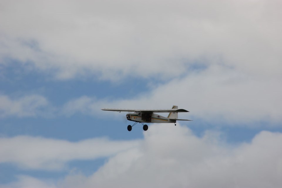 A radio controlled plane soars through the air during a demonstration.