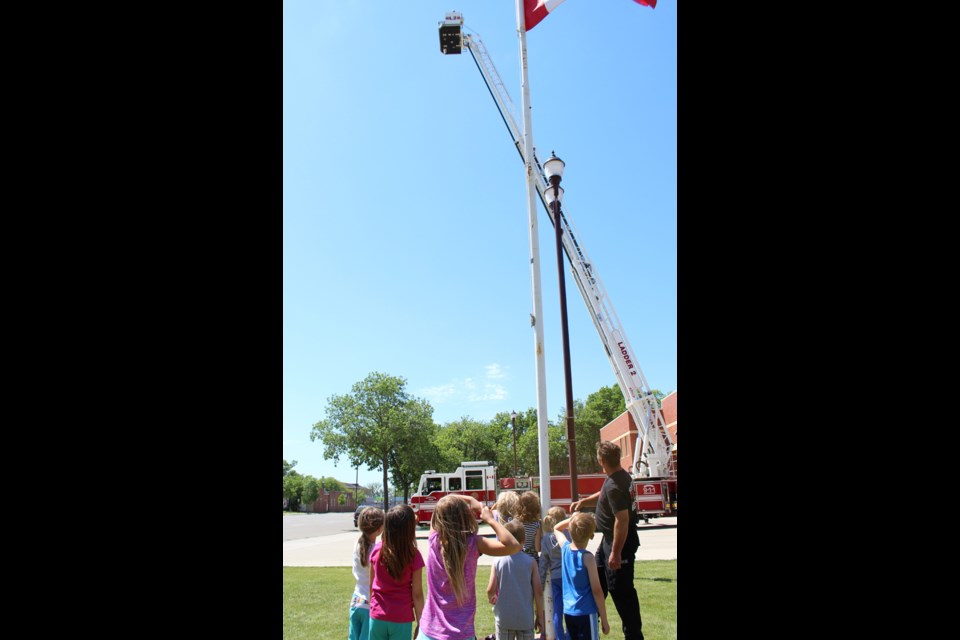 Up, Up, but not away Grade 3 students watch their teacher go up in the fire department’s ladder truck. Every year at this time, firefighters welcome the young ones for a tour of the state-of-the-art facility on Smith Street.