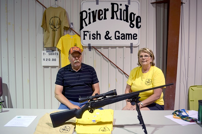 Kathy Thomas, president of the River Ridge Fish and Game organization in Canora, tended a table at the group’s gun show on June 11 and 12, accompanied by her husband Hal.
