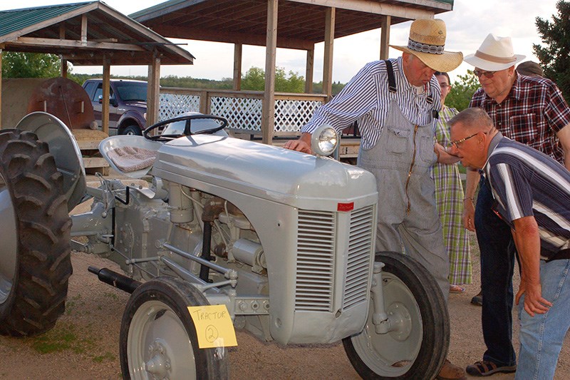 Edgar Thorson showcased his 1950 Massey Ferguson tractor to Lorne Plaxin and Rudy Romaniuk.