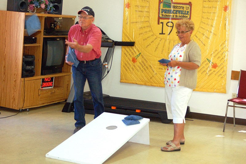 Roy and Geraldine Fairburn competed together in a bean bag toss game during the Preeceville Club 60 windup fun day.