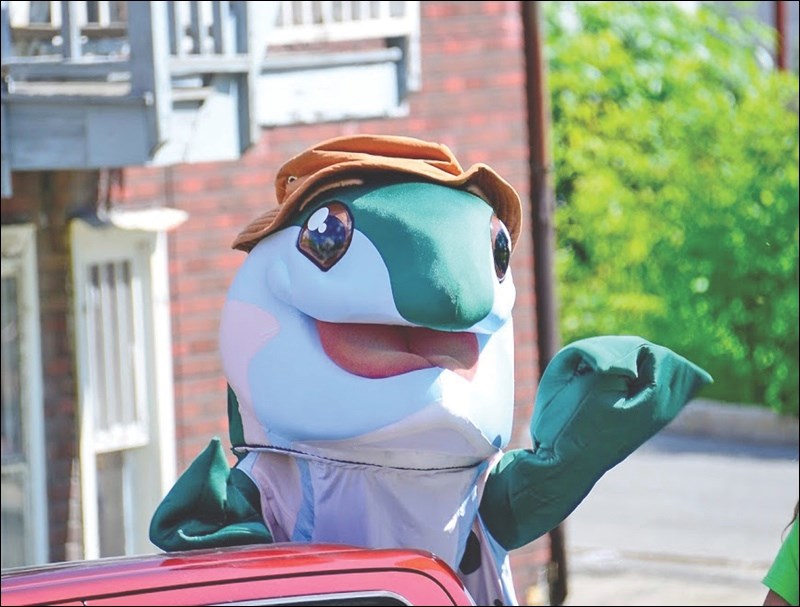 Teddy Trout waves to spectators of the Canada Day Parade.