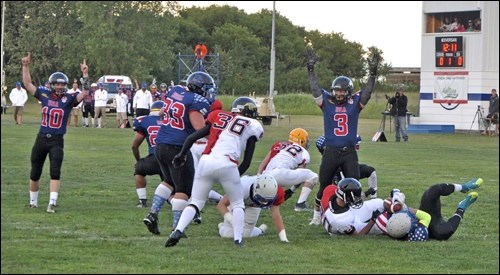 Team USA players Sam Middleton (No. 10) and Cooper Gray (No. 3) raise their arms as Gabe Haney scores the first touchdown to put their team up 8-0 in the Can-Am Game.