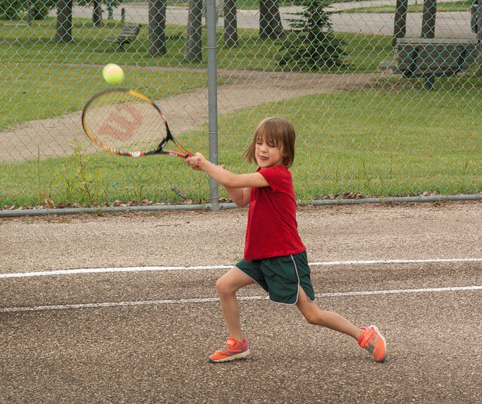 Raising a Racquet Five-year-old Avery Lammers hits the court with her father David Lammers and brother Garin Sunday afternoon. The trio played games against one another at the Knights of Columbus Park.