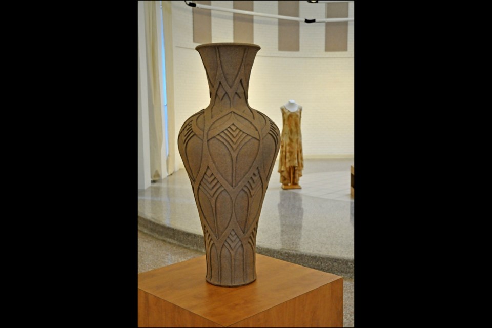 "Carved Pot" by Gail Carlson of Prince Albert. In the background is a silk/wood blend "Untitled Dress" by Lindsay Embree of Saskatoon. Photos by Jayne Foster