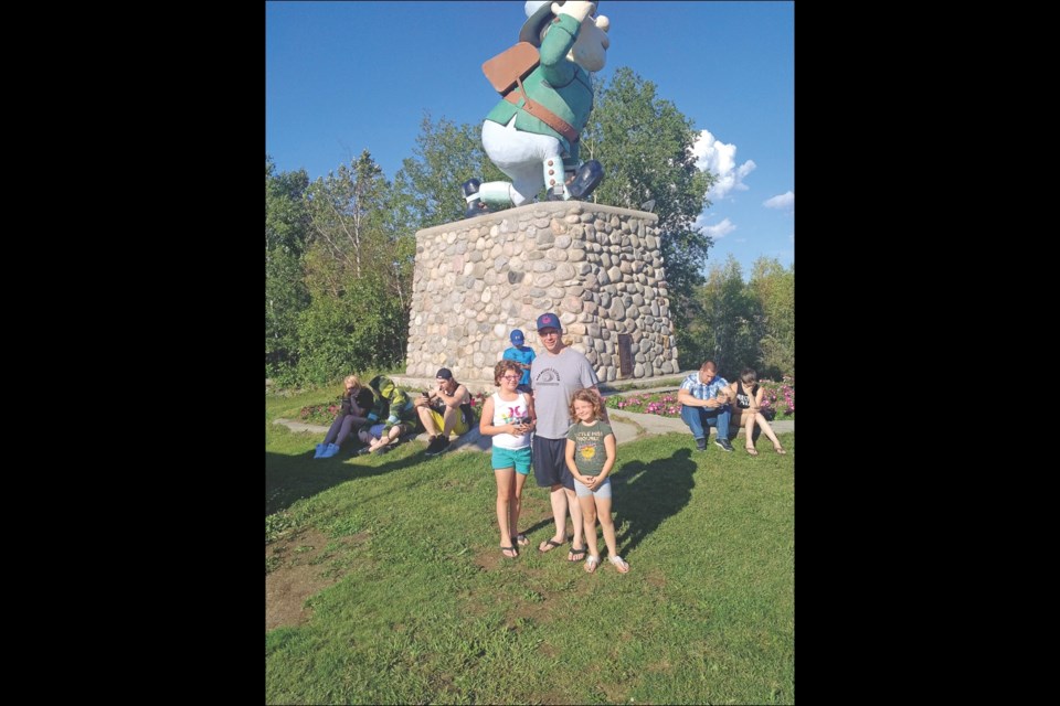 Mark Svaren and his daughters, Lacey (left) and Mackenzie, were among people gathered at the Flinty PokéStop on Tuesday, July 19. A PokéStop is a location where Pokémon creatures are more likely to spawn in the new augmented reality game Pokémon GO.