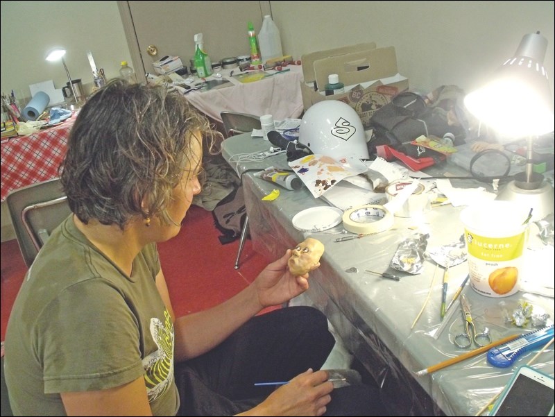 Cathy Woods crafts a marionette.