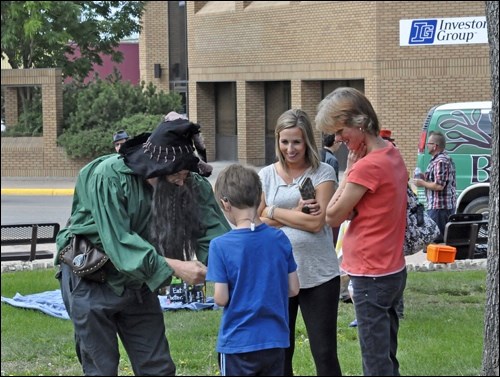 A young attendee meets one of the festival performers