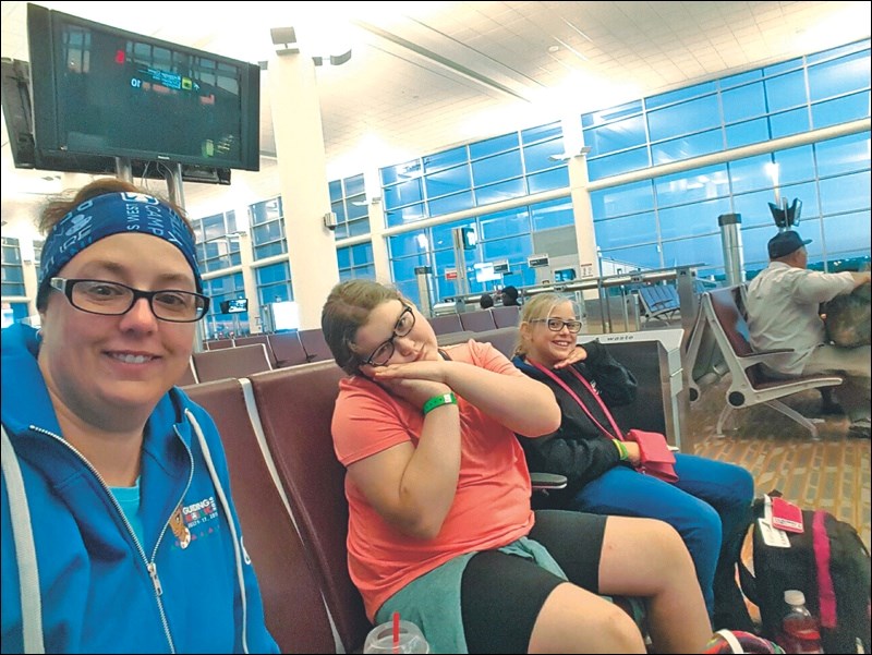 Flin Flon Girl Guide leader Nikki Rosenberg and members Haylee Dallas (centre) and Eden Morris wait in the Edmonton airport on their return from Guiding Mosaic 2016, an international camp held in Sylvan Lake AB this month.