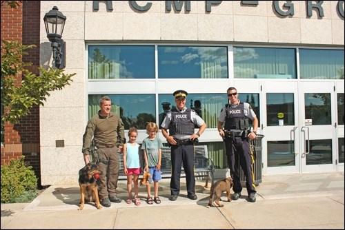 Cpl. Melvin Sansome and Diego, Grace and Lucas Anthony, Sgt. Darcy Woolfitt and Cst. Mike Baker with Jenni outside the Battleford RCMP detachment. Lucas was a winner in the RCMP Name the Puppy contest. Photos submitted