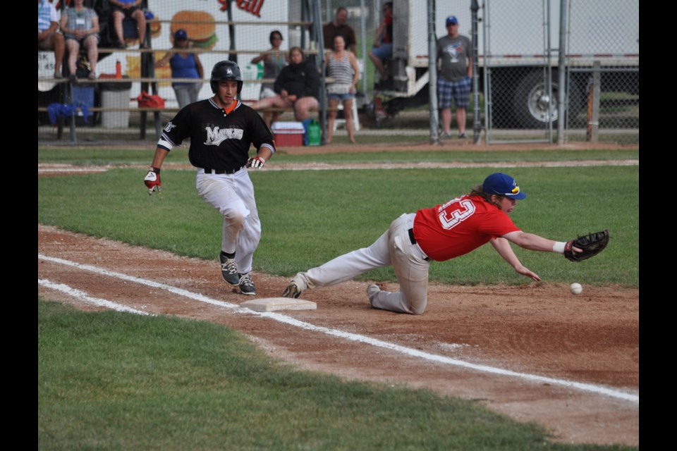 Brandon Marlins batter Jay Pringle runs to first base while South Jasper Jays first baseman Mitchell Brodie stretches out to make a catch.