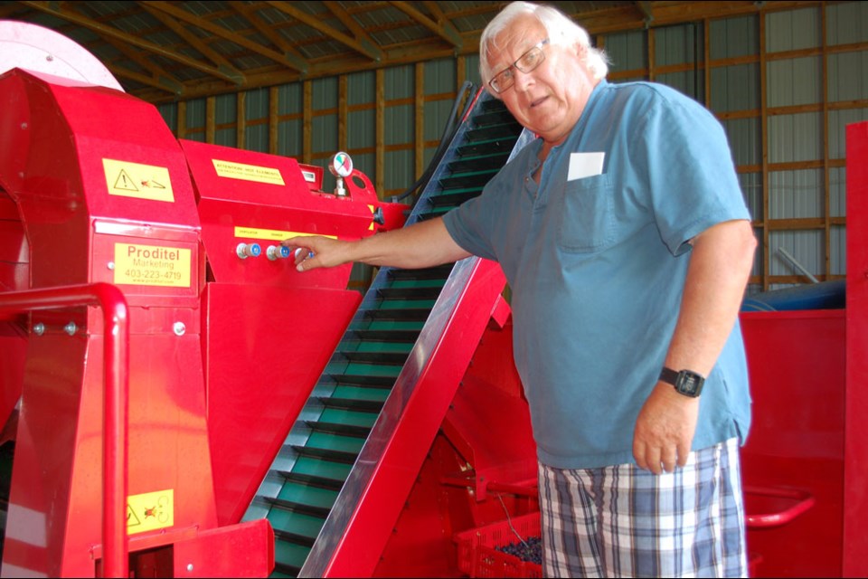 Basil Ciepliski with the berry harvester