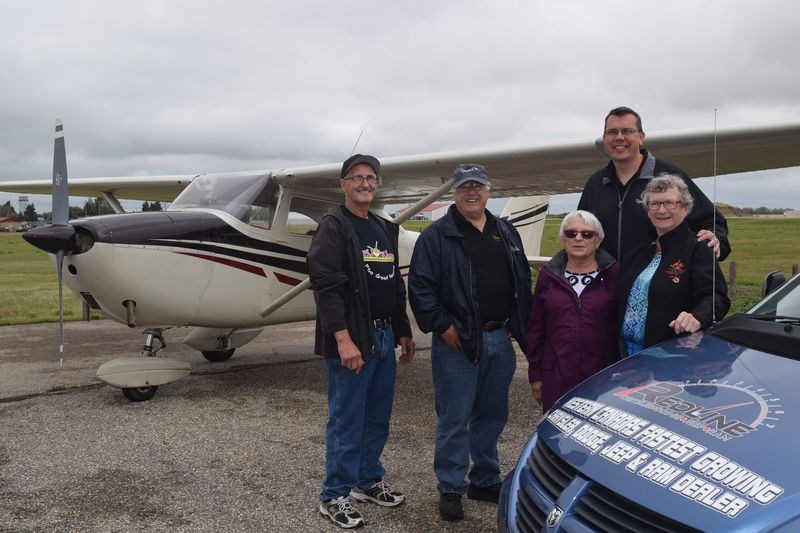 The two women who were in Kamsack last week as judges of the Communities in Bloom competition, toured the community from the ground, and the air. With, from left, Leo Renaud, the pilot; Councillor Rick Aikman, and Kev Sumner, the recreation director, were the judges Brenda Winny, left, of Rosetown and Marion Kelly of Unity.