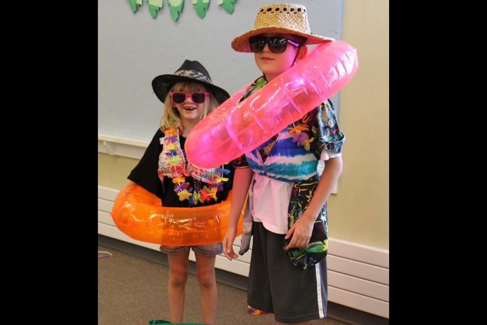 The Yorkton Public Library gave kids the chance to take a trip to Hawaii with the Hawaiian Hullabaloo party, featuring a wide range of island inspired fun and games. Pictured is the end of the tourist relay, where teams race to fit their tourist with all the accessories they need to enjoy a day at a Hawaiian beach.