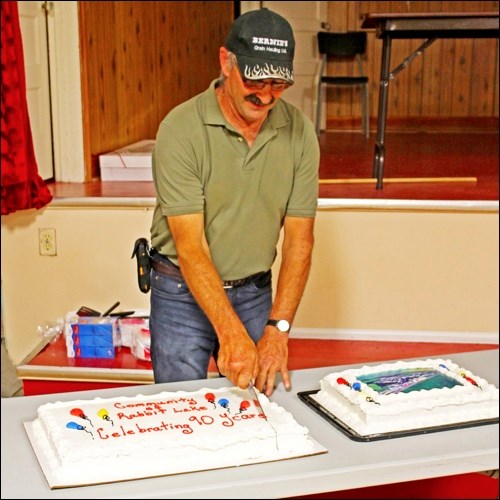 Coucillor Eric Kuffert cutting the birthday cake. Photos by Alan Laughlin