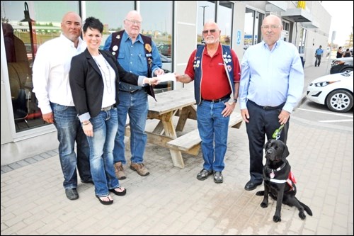 McDonalds provided a cheque for $4,000 towards a Lions Foundation of Canada dog guide program Thursday. Shown in the photo are Dave Taylor and Sharon Taylor (McDonalds), Gib Volk (North Battleford Lions Club), Lawrie Ward (North Battleford Lions) and Ernie Callow. Also seen is Ernie’s hearing dog guide, Lyra. Photos by John Cairns