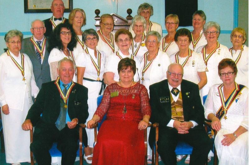 Officers of Hiawatha chapter of the Eastern Star assembled with members of the grand family during a visit in Kamsack on August 26. They were: (back row) Rod Lee of Foam Lake, Sally Bishop of Kamsack, Lil Parker of Yorkton, Marjorie Orr of Kamsack, Ellie Kilmister of Kamsack, Kathy Gordon of Yorkton and Ruby Lee of Foam Lake; (middle row), Kathleen Achtymichuk of Kamsack, Earl Greiner of Yorkton, Milena Hollett of Kamsack, Susan Bear of Kamsack, Mary Welykholowa of Kamsack, Vicky Tanton of Stenen, Marianne Washburn of Yorkton, Judy Stone of Kamsack and Maxine Greiner of Yorkton, and (front) Stan Stone of Kamsack, Cannida Coventry of Mantario, Ernie Butz of Regina and Nancy Leson of Canora.