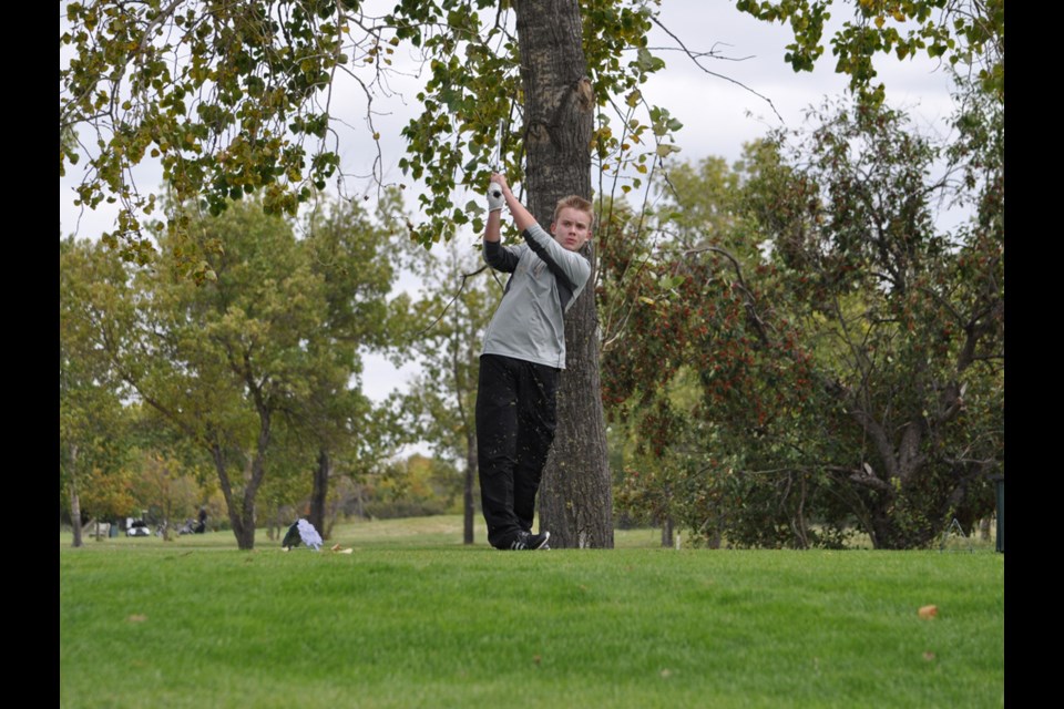 Radville School's Ryan Neisznes hits a drive off the eighth tee.