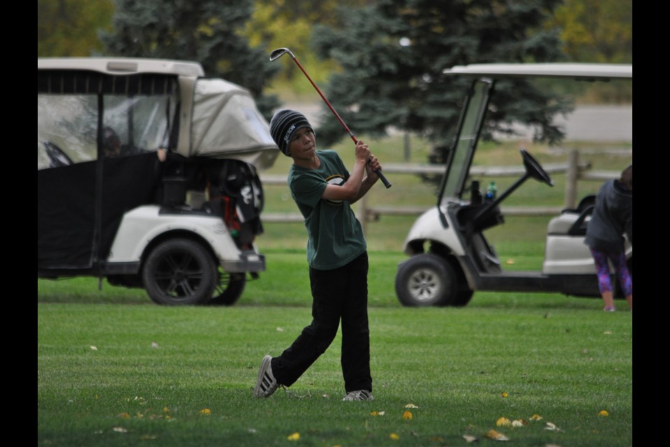 Ryan Chernoff hits his approach shot onto the second hole green.