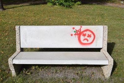 A park bench in front of the Sylvia Fedoruk Centre has been painted with a graffiti symbol.