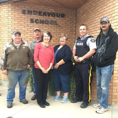 The council members were photographed with their guests in front of Endeavour School. From left, were: Garry Walters, Brad Romanchuk, Wagantall, Kathleen Ambrose, Smith and James German.
